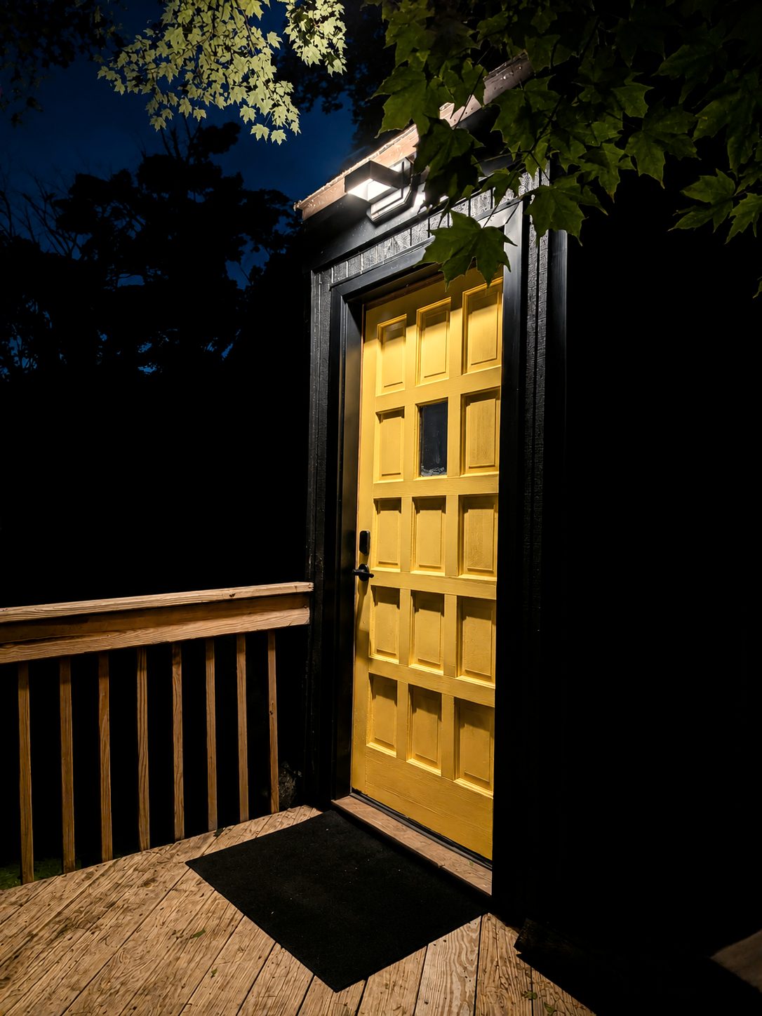 The yellow front door at night